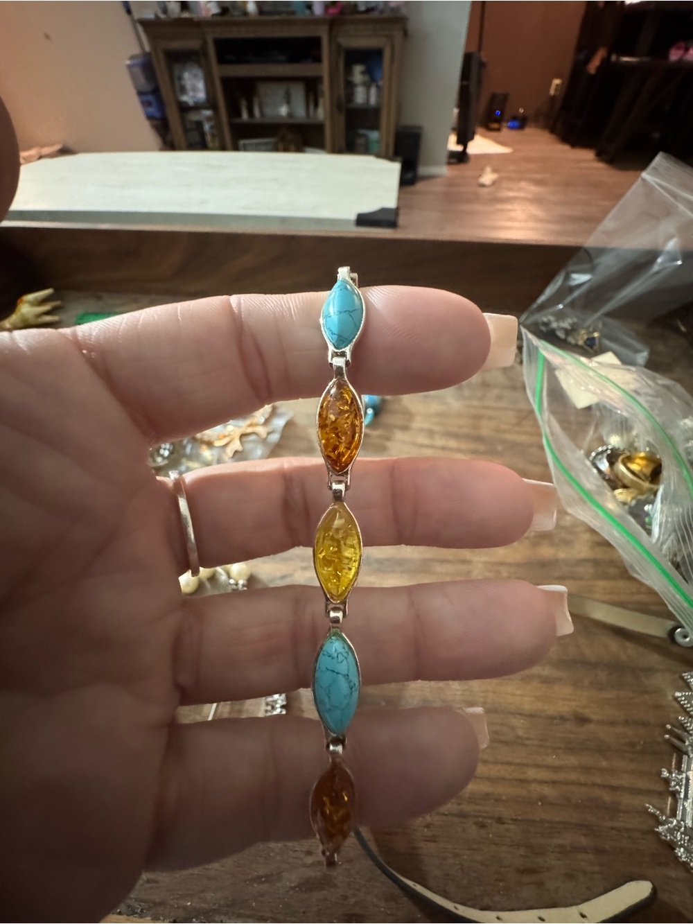 sterling silver link bracelet featuring marquise-cut turquoise and Baltic amber
